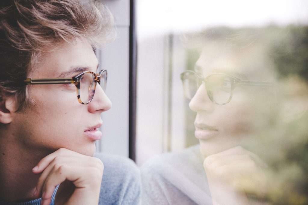 man looking at his reflection